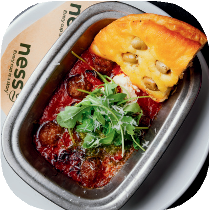 Nesso Coffee baked meatballs with marinara sauce, ricotta, jalapeno garlic butter, pesto, and olive focaccia bread
