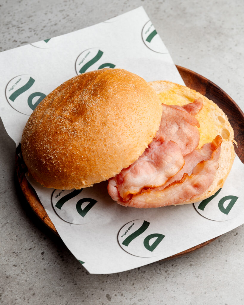 Bacon bap at Nesso Coffee Leeds with maple crispy cured bacon, ricotta cheese spread and brioche bap